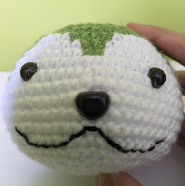 Close-up of the mouth embroidery on Sommie's head